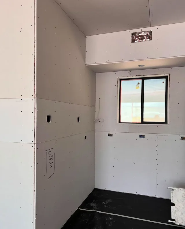 Interior wall surfaces around a window and an overhead soffit.