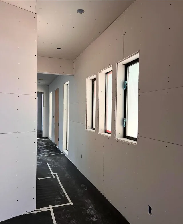 An interior corridor with a row of window openings.